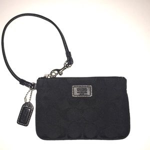 Coach jacquard canvas wristlet with leather trim.